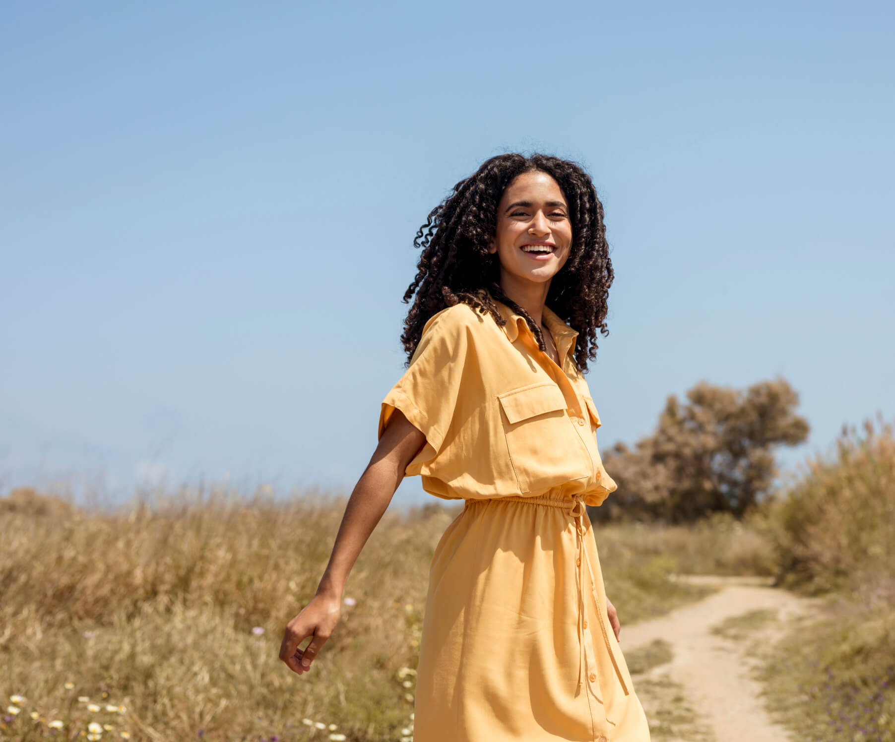 A Fertility2U patient walking outdoors and smiling
