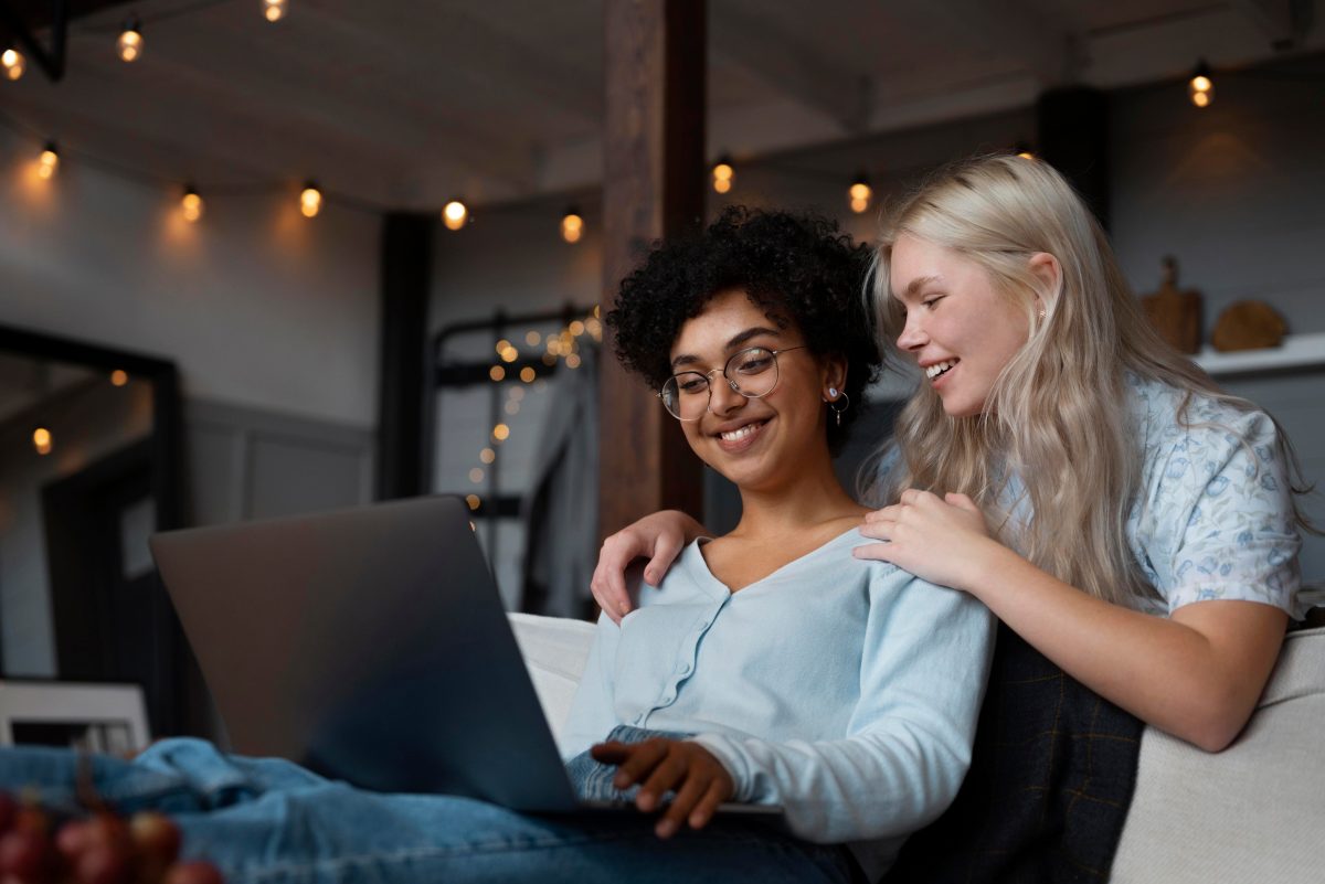 Two women talking warmly together, one supporting the other