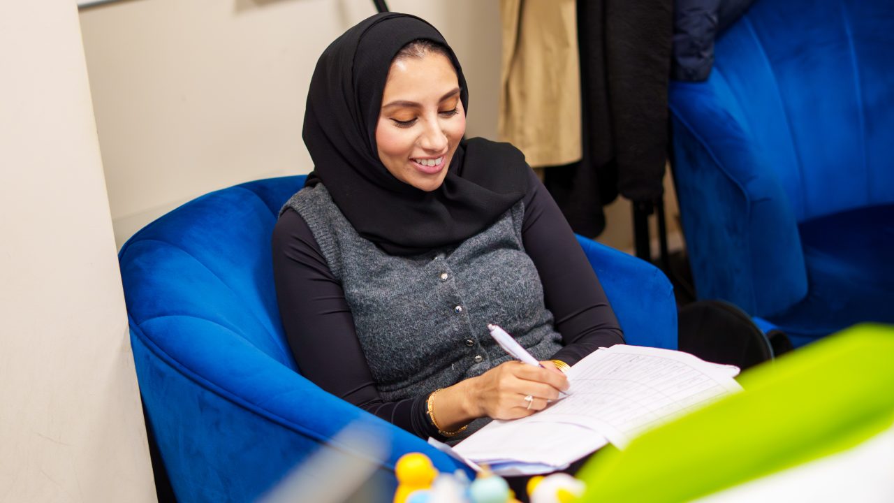 A fertility patient completing her treatment paperwork at home