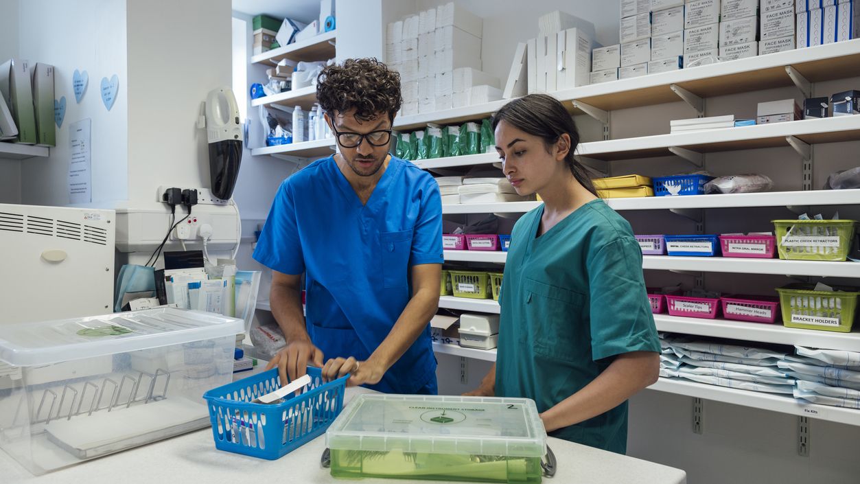 Two pharmacy team members preparing medication in the dispensary