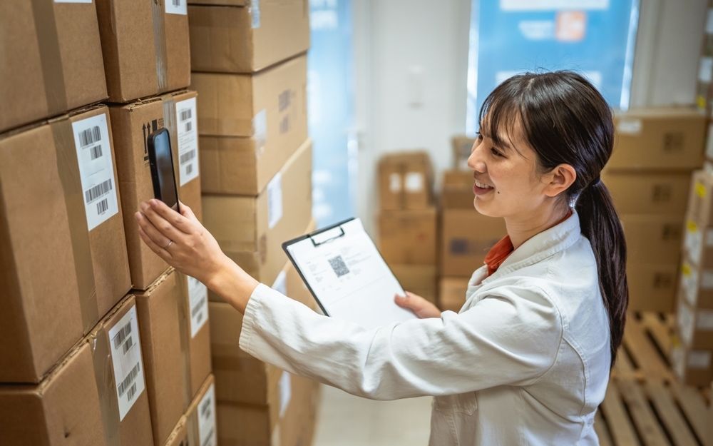 A pharmacy team member scanning a parcel label in the dispatch store