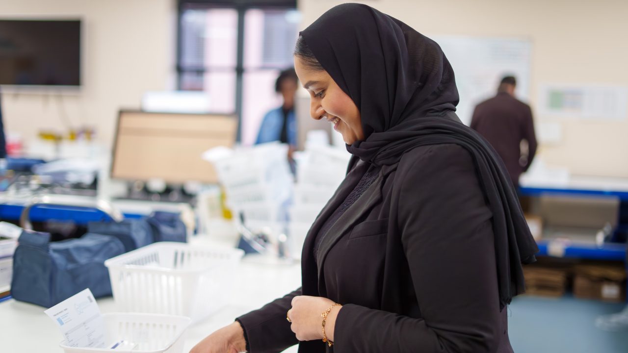 A pharmacy team member preparing a prescription order