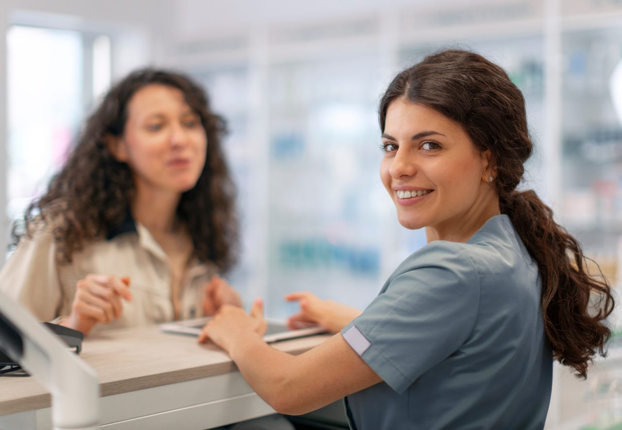 Two members of the pharmacy team discussing a patient’s treatment